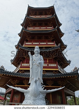 A picture of Guanyin or KwanIm Goddess in front of a pagoda or temple, located in north jakarta, Indonesia