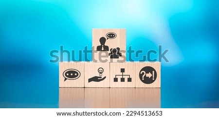 Wooden blocks with symbol of coaching concept on blue background