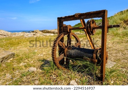 Old weathered rusty winch on the west coast of Hammeren headland at the northern tip of Bornholm Island, Denmark, Scandinavia, Europe.