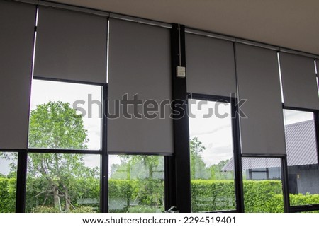 Gray blind or curtains on the glass window Royalty-Free Stock Photo #2294519401