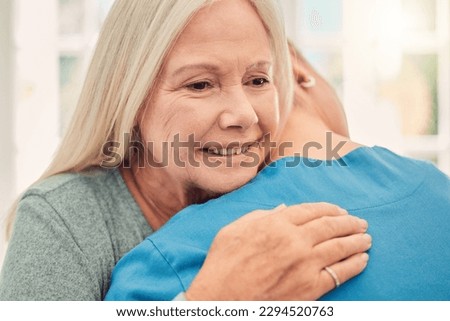 A kind and compassionate act is often its own reward. Shot of a nurse hugging to her female patient at home.