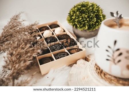 Chocolate candies and white coffee on white background