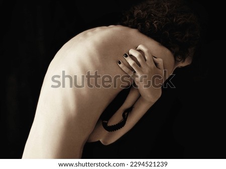 Anorexia, bulimia and back of woman in studio for weight, obsession and ashamed on black background. Eating disorder, mental illness and spine of girl suffering phobia, body dysmorphia or disgust Royalty-Free Stock Photo #2294521239