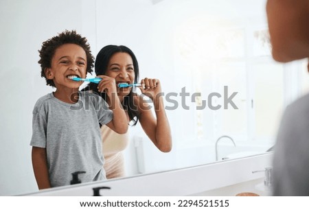 Learning, mother and son brushing teeth, dental hygiene and wellness at home, bathroom and bonding. Family, female parent or mama with male child, kid or boy with oral health, cleaning mouth or smile Royalty-Free Stock Photo #2294521515