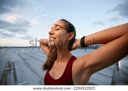 Enjoy the journey of becoming your best self. Shot of a young woman taking a break while exercising outside. Royalty-Free Stock Photo #2294522023