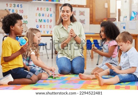 Our day is not complete without our favourite songs. Shot of a teacher singing with her preschool children. Royalty-Free Stock Photo #2294522481