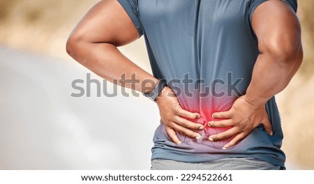 This injury is really getting in the way of progress. Shot of an unrecognizable man standing alone outside and suffering from backache during his run. Royalty-Free Stock Photo #2294522661