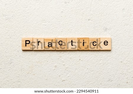 practice word written on wood block. practice text on table, concept.