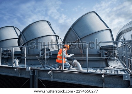 Engineer under checking the industry cooling tower air conditioner is water cooling tower air chiller HVAC of large industrial building to control air system. Royalty-Free Stock Photo #2294550277