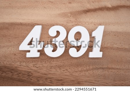White number 4391 on a brown and light brown wooden background.