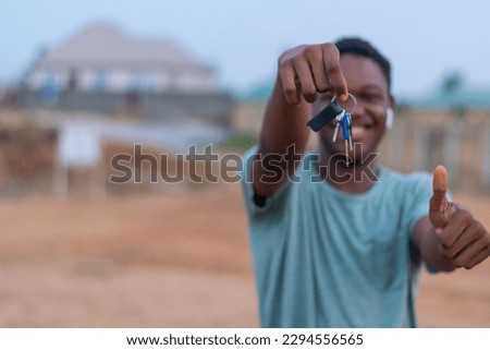 young man holding bunch of keys to a new apartment. mortgage or realtor agent making transaction on real estate.