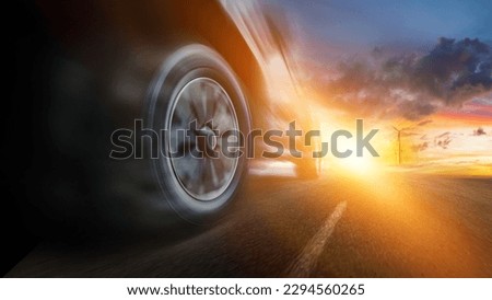 Speeding car with natural energy technology. Low angle side view of car driving fast on motion blur