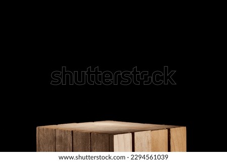 Classic wooden box on a black background as an ideal base for displaying cosmetic, food and other products. caja de madera clásica en fondo negro como base ideal para exhibir productos Royalty-Free Stock Photo #2294561039