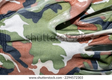 Camouflage elastic gloves background.Camouflage work gloves.Camouflage rubberized gloves.