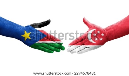 Handshake between Singapore and South Sudan flags painted on hands, isolated transparent image.