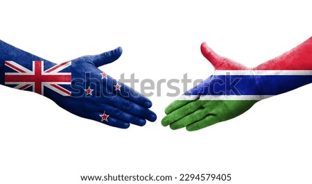 Handshake between Gambia and New Zealand flags painted on hands, isolated transparent image.