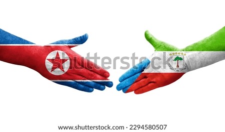 Handshake between Equatorial Guinea and North Korea flags painted on hands, isolated transparent image.