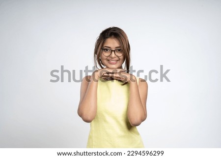 Joyful attractive young woman dancing against White background