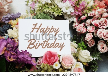 Happy Birthday text message on paper card with beautiful flowers decoration