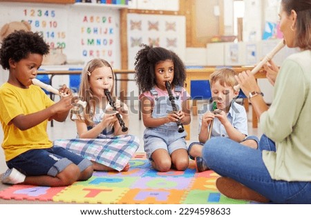 We love learning about musical instruments. Shot of children learning about musical instruments in class. Royalty-Free Stock Photo #2294598633