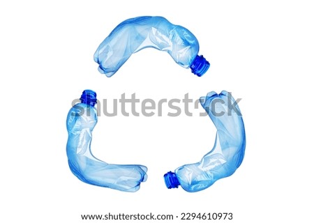 Recycle symbol made of blue plastic bottles isolated on white background. Concept of recycle with creative recycle sign.