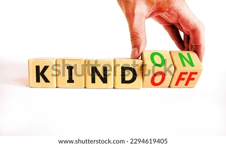Kind on or off symbol. Businessman turns wooden cubes and changes word Kind off to Kind on. Beautiful white table white background. Business and kind on or off concept. Copy space.