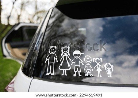 Happy family on board. Sticker on the back of car. Four kids.