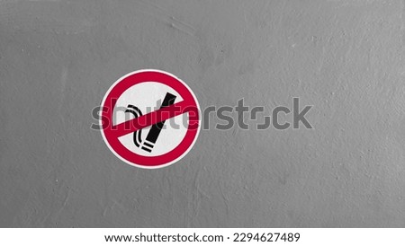 Designated smoking area. Smoking banned sign. Cigarette warning sign on grey concrete wall with copy space.