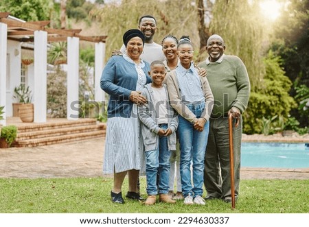 Picture perfect family. Full length portrait of a multi-generational family standing outside in the garden.