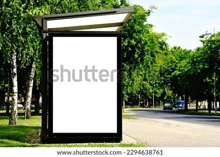 bus shelter at busstop. blank white lightbox. empty billboard. bus shelter ad. glass and aluminum structure. transit station. urban setting. city street background. stone sidewalk. base for mockup