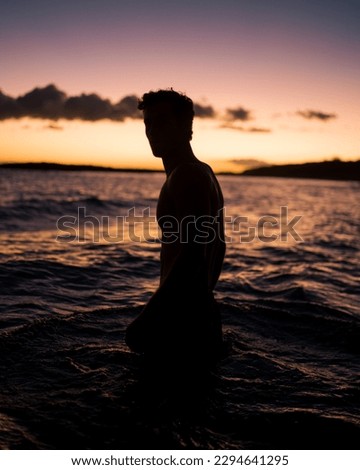 Man wading in the water at Sunset beach in Hawaii Royalty-Free Stock Photo #2294641295