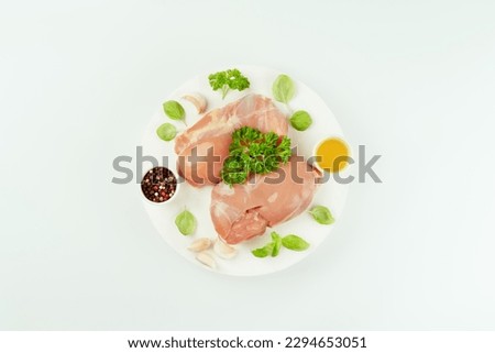 Fresh raw skinless chicken thigh meat with fresh herbs on a gray background.Copy space.Ogranic food,healthy eating.Food concept.Top view.Food for retail.