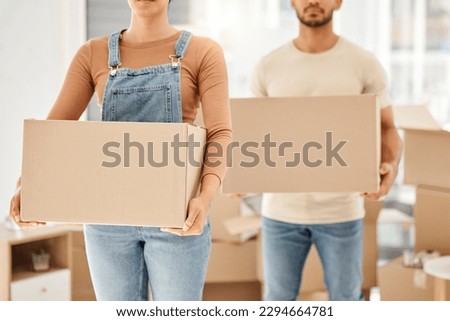 Lets pack up and go. Closeup shot of an unrecognisable couple carrying boxes while moving house. Royalty-Free Stock Photo #2294664781