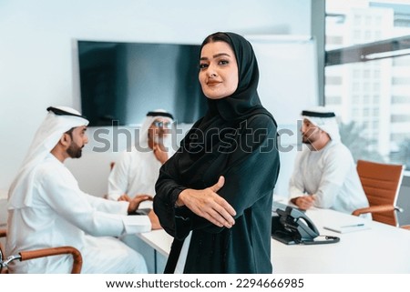 Group of middle-eastern corporate business people wearing traditional emirati clothes meeting in the office in Dubai - Business team working and brainstorming in the UAE Royalty-Free Stock Photo #2294666985