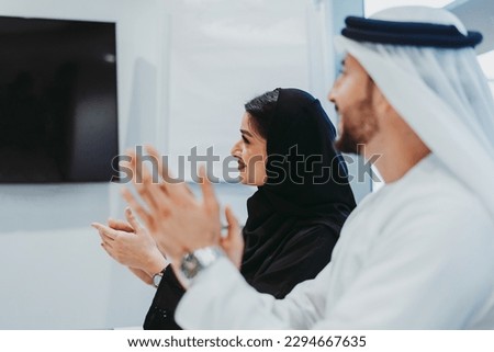 Group of middle-eastern corporate business people wearing traditional emirati clothes meeting in the office in Dubai - Business team working and brainstorming in the UAE Royalty-Free Stock Photo #2294667635