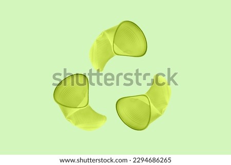 Recycle symbol made of green plastic cups. Concept of recycle with creative recycle sign.