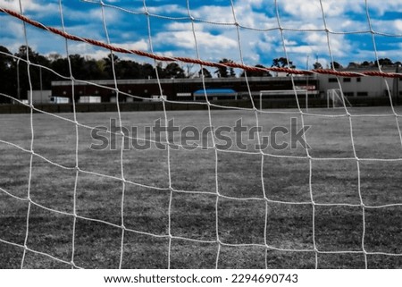 A picture of the textures of a soccer net and a view.