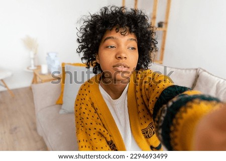 Happy african american teen girl blogger smiling face talking to webcam recording vlog. Social media influencer woman streaming making video call at home. Headshot portrait selfie webcamera view Royalty-Free Stock Photo #2294693499