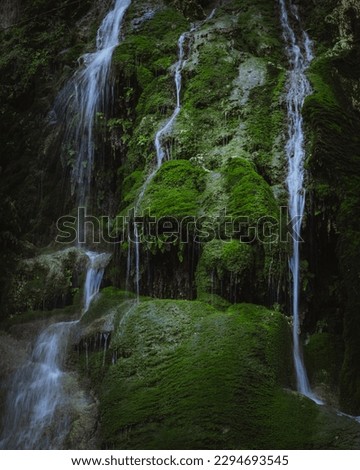 Kritou Tera village famous waterfall in Paphos district, Cyprus. Beautiful deep green moss covered rock with water fall streaks.  Royalty-Free Stock Photo #2294693545