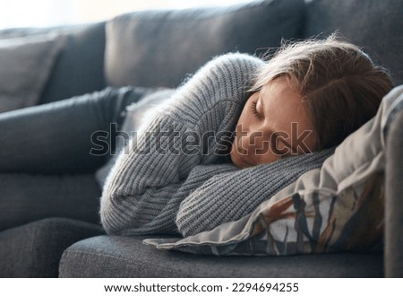 Life can be so bleak. Shot of a young woman lying on her couch feeling depressed. Royalty-Free Stock Photo #2294694255