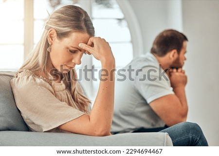 One young woman feeling frustrated and annoyed after an argument with her husband. A wife feeling distant after fighting due to marriage problems. A negative situation that could end up in divorce Royalty-Free Stock Photo #2294694467