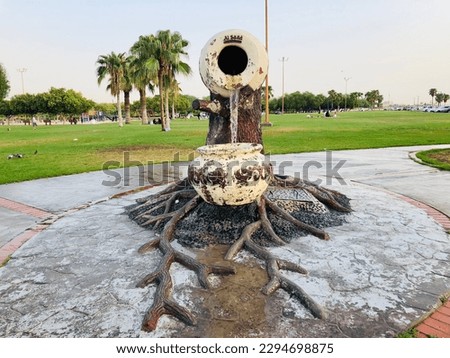 Artistic fountain at a beach side park with lush green scenery  Royalty-Free Stock Photo #2294698875