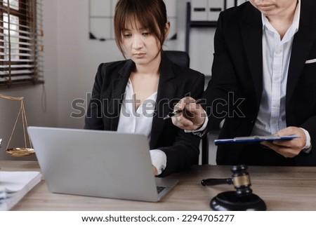 Close-up of asian lawyer and client discussing at office desk, law and justice concept. 
