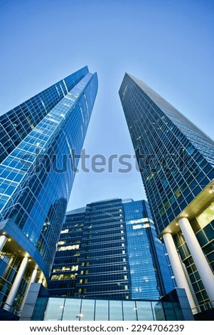 Office and residential skyscrapers on bright sun and clear blue sunset sky background. Commercial real estate. Modern business city district. Office buildings exterior. Financial city district.  Royalty-Free Stock Photo #2294706239