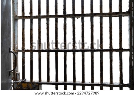 Rusty paint chipped prison bars isolated on white background  Royalty-Free Stock Photo #2294727989