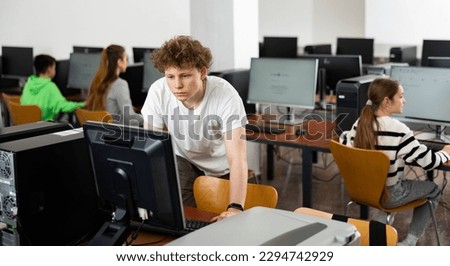 Modern teenage student learning basics of programming in group course in computer college Royalty-Free Stock Photo #2294742929
