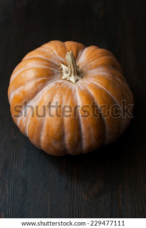 A pumpkin on a grunge wooden table