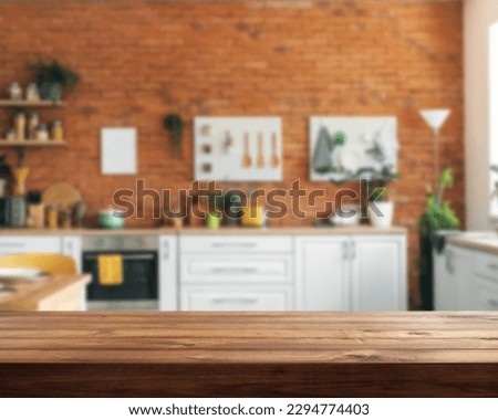 empty wood table with blurred modern interior kitchen, window with sunny mood 
