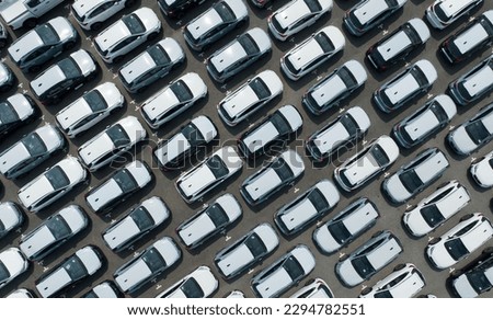 Aerial view of new cars stock at factory parking lot. Above view cars parked in a row. Automotive industry. Logistics business. Import or export new cars at warehouse. Big parking lot at port terminal Royalty-Free Stock Photo #2294782551