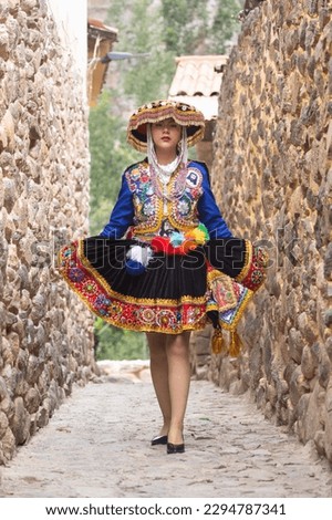 Beautiful girl with traditional dress from Peruvian Andes culture. Young girl in Ollantaytambo city in Incas Sacred Valley in Cusco Peru. Royalty-Free Stock Photo #2294787341